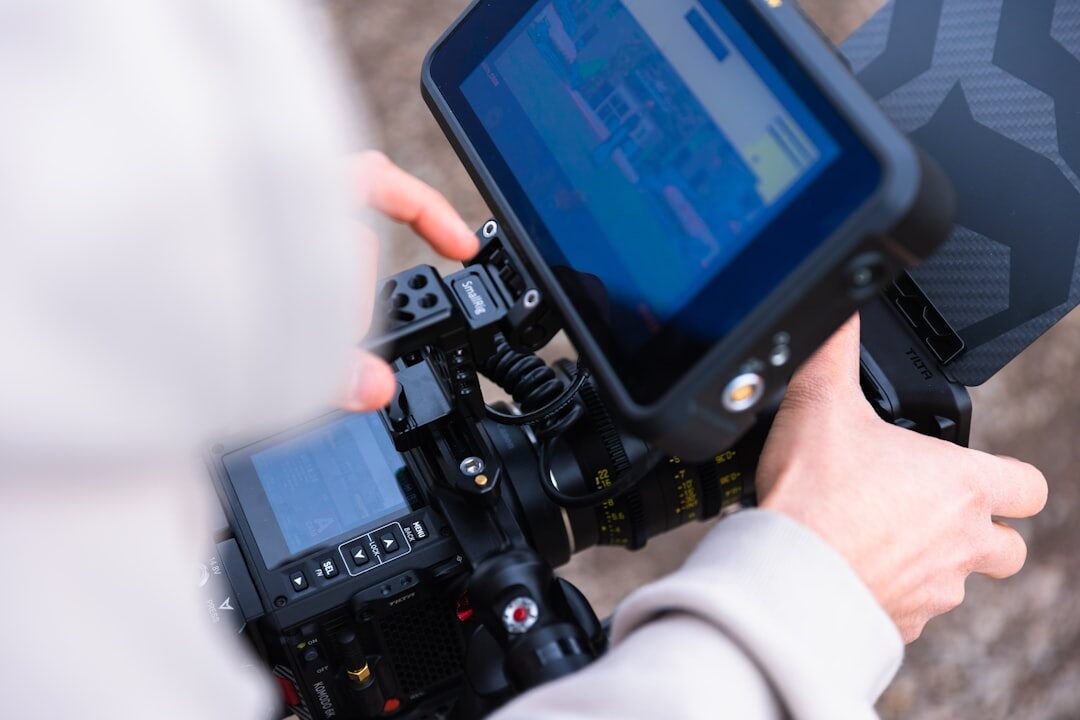 Close-up of hands operating a multi-camera video switcher panel